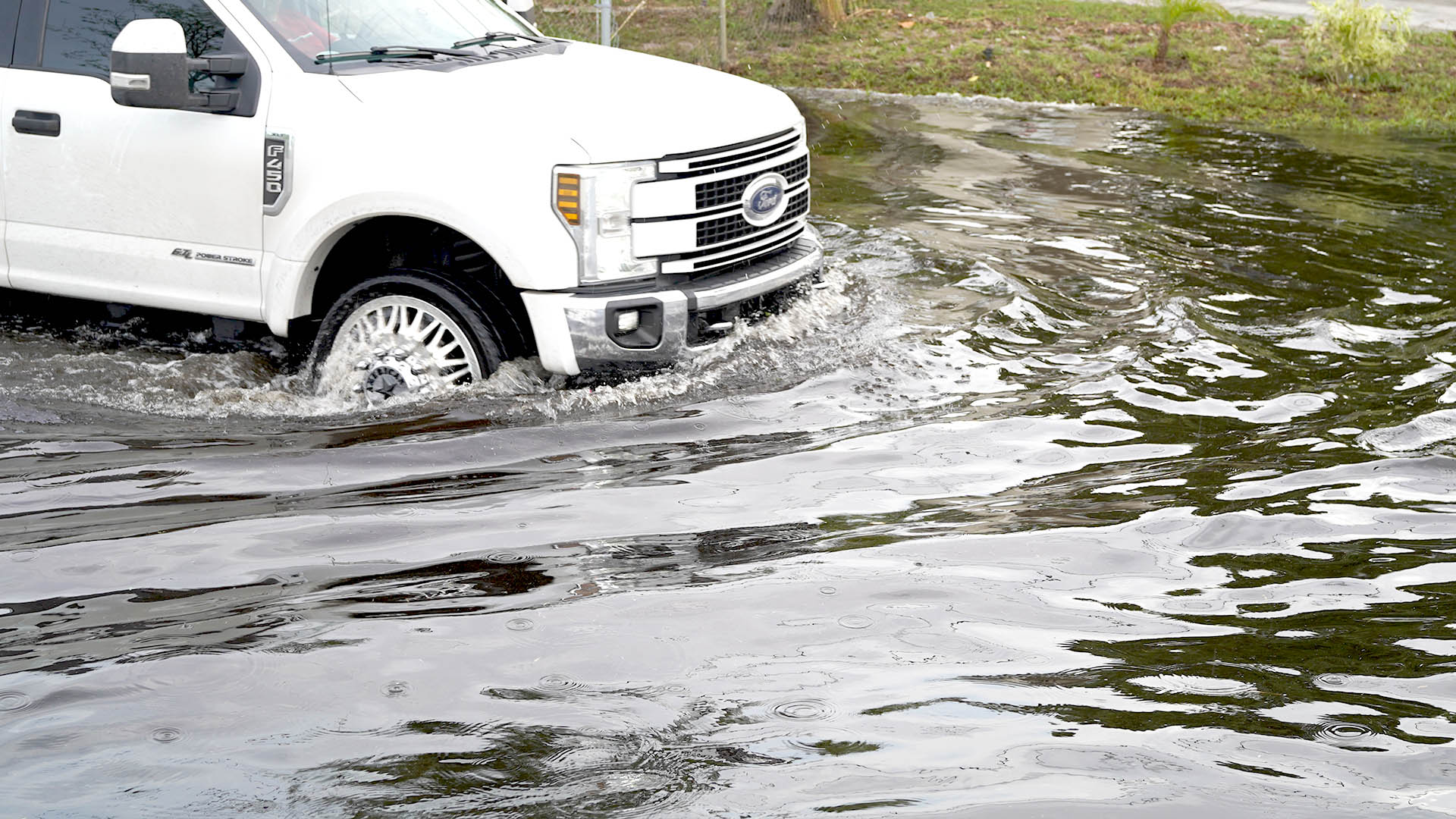 flooded street with high water and truck